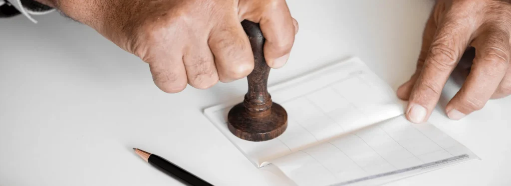 Hands stamping a commercial property document