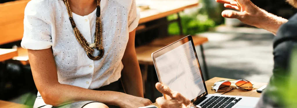 Property buyers discussing a purchase with an adviser over a laptop