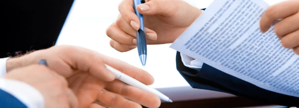 A client reviewing and signing a will document with a solicitor